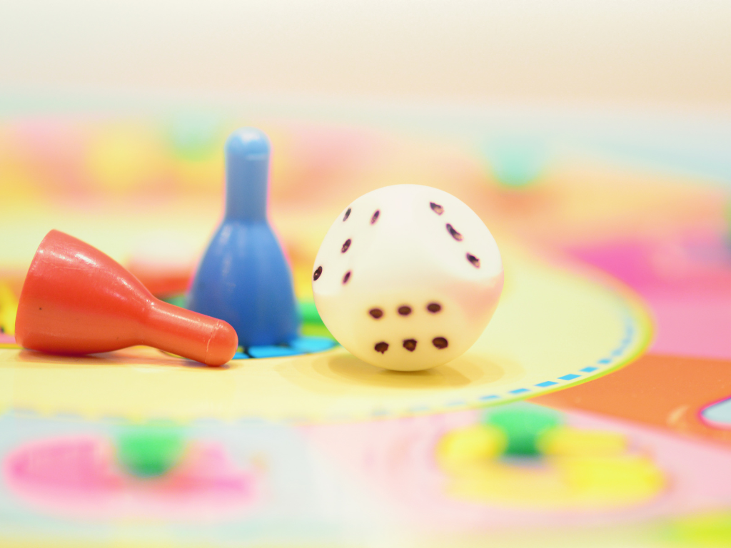 Dice and game pieces on a game board